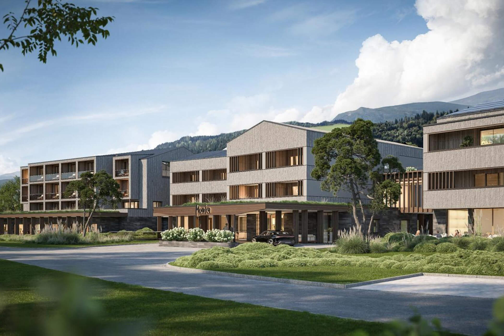 Ein modernes Hotelgebäude mit großen Fenstern, umgeben von Grünflächen und Bergen unter blauem Himmel. - Helplan
